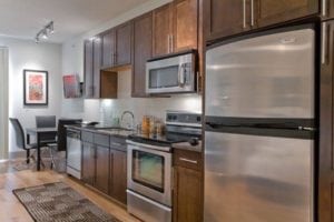 Uptown Dallas - Modern Apartments Near West Village #008 - Dark Kitchen Cabinets